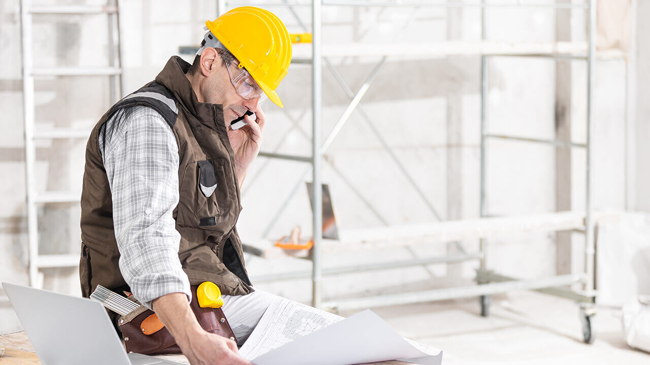 Building contractor talking on a mobile phone.