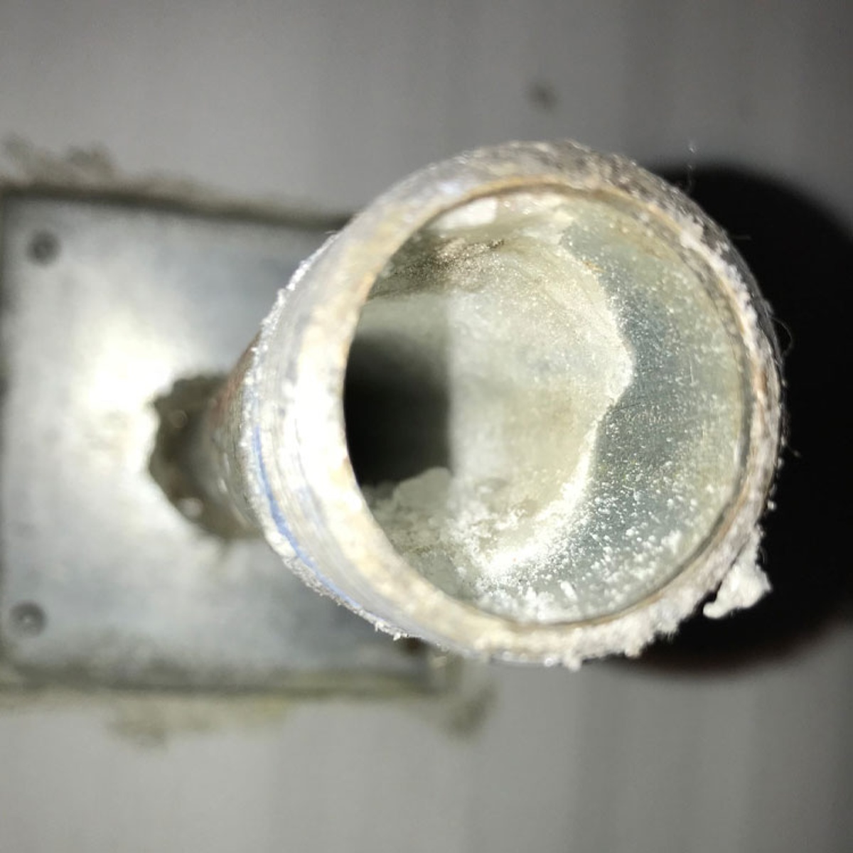 The interior view of a pipe with corrosion.